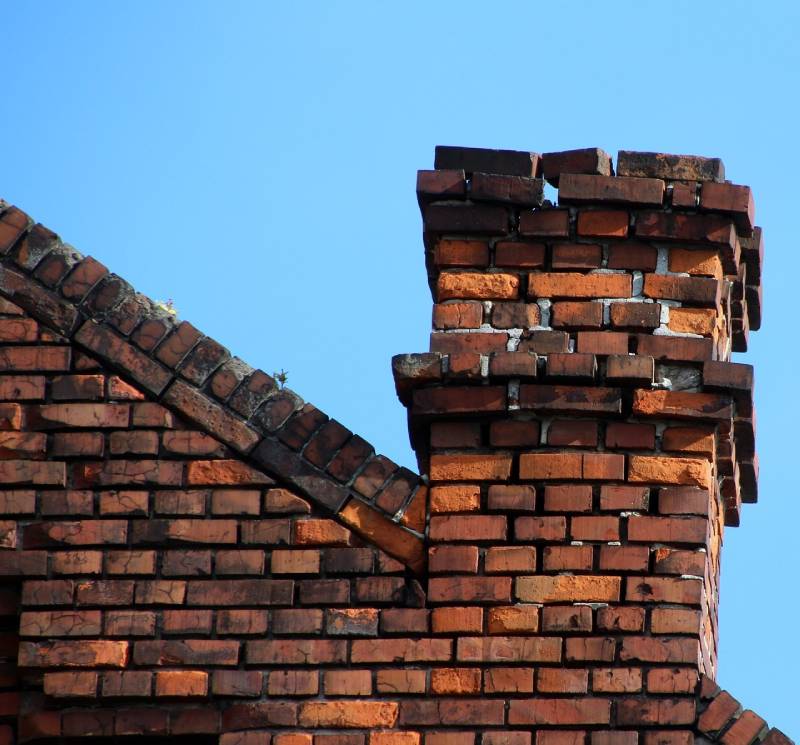 Damaged chimney on an Weston home showing cracks and missing mortar